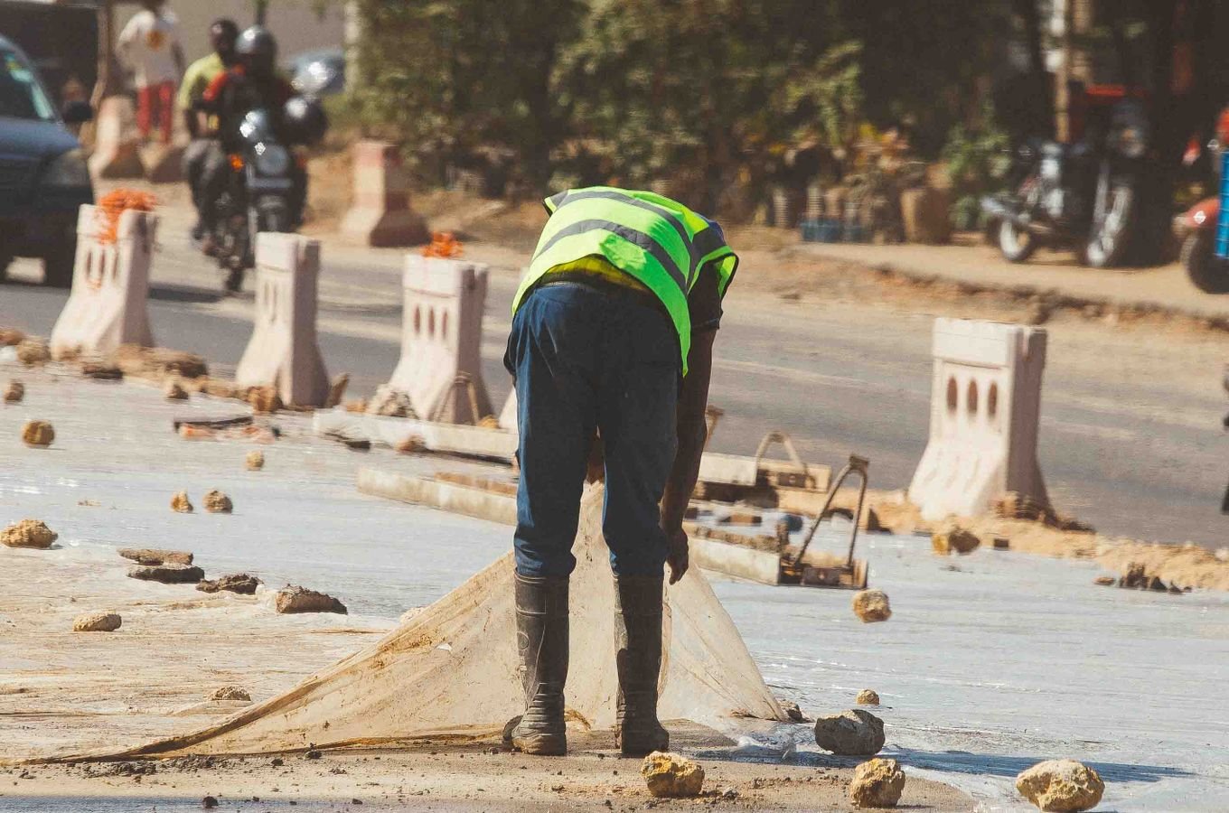 Construction workers laying an asphalt road surface