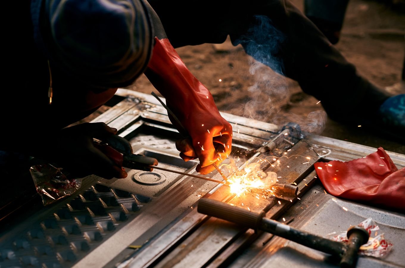 Industrial worker welding metal with sparks
