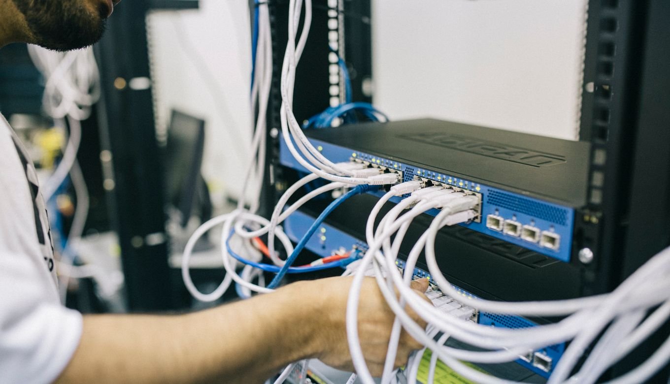 IT professional configuring network cables in a server rack